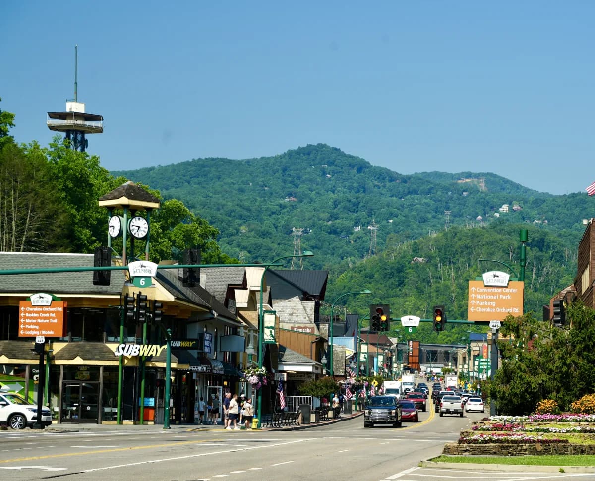 Downtown Gatlinburg Parkway with shops, traffic, and mountain backdrop