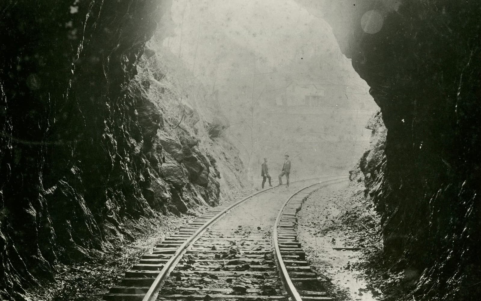 Men standing on railroad tracks outside the Cowee Tunnel near Dillsboro in the 1890s